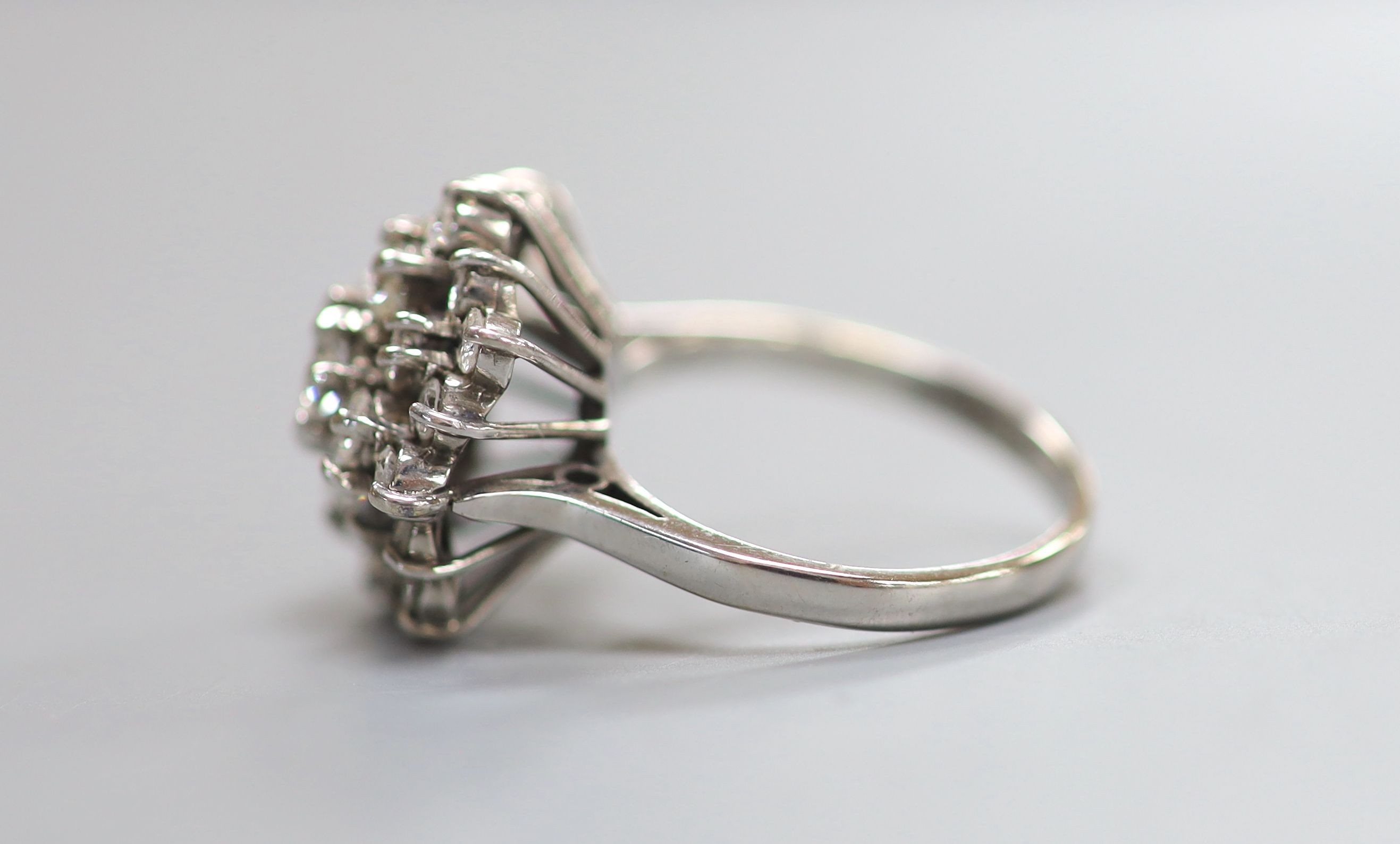 A modern 18ct white gold and diamond set flower head cluster ring, size M, gross weight 6.6 grams.